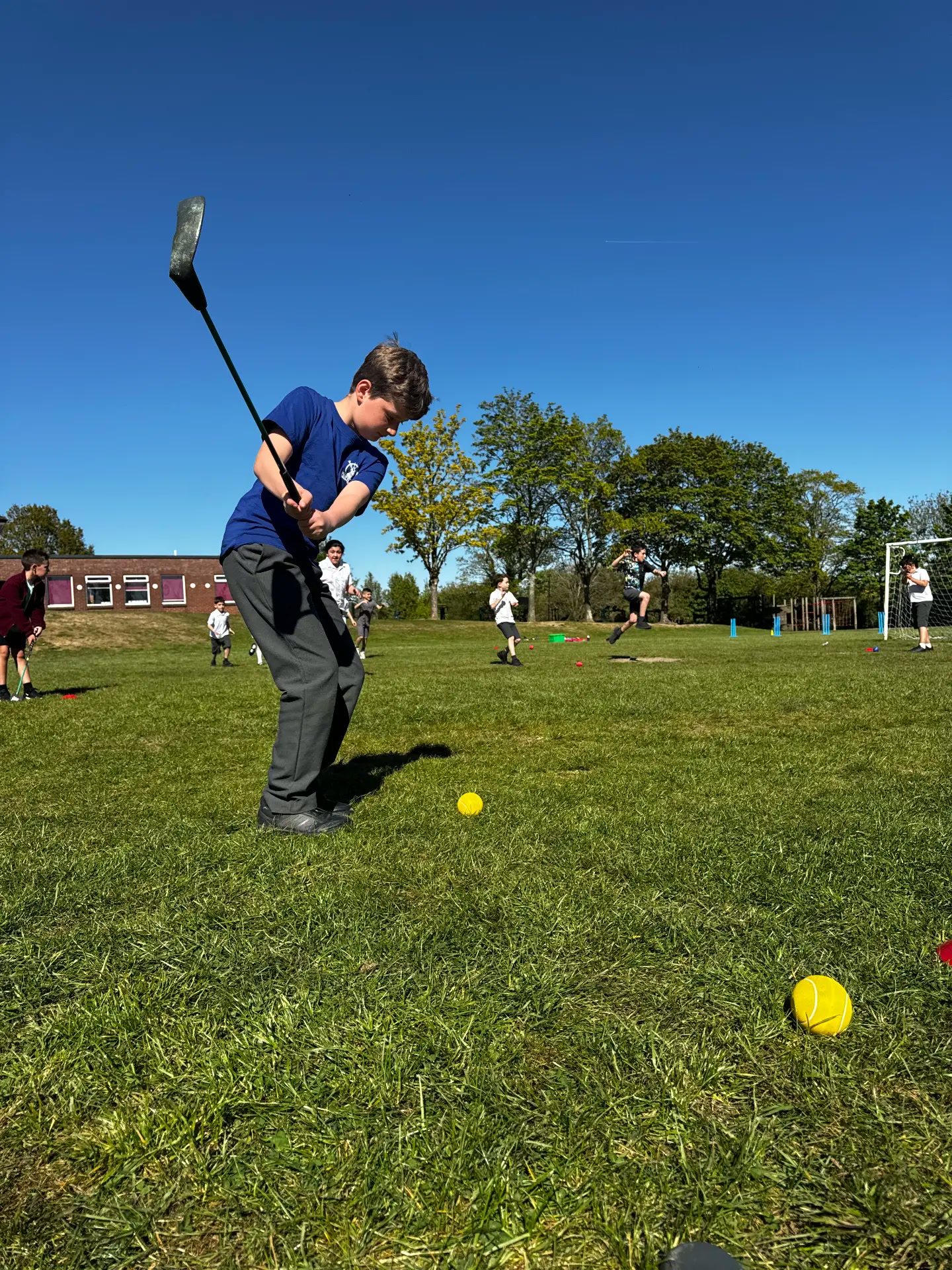 Pupil playing a shot during a Golfstars school session