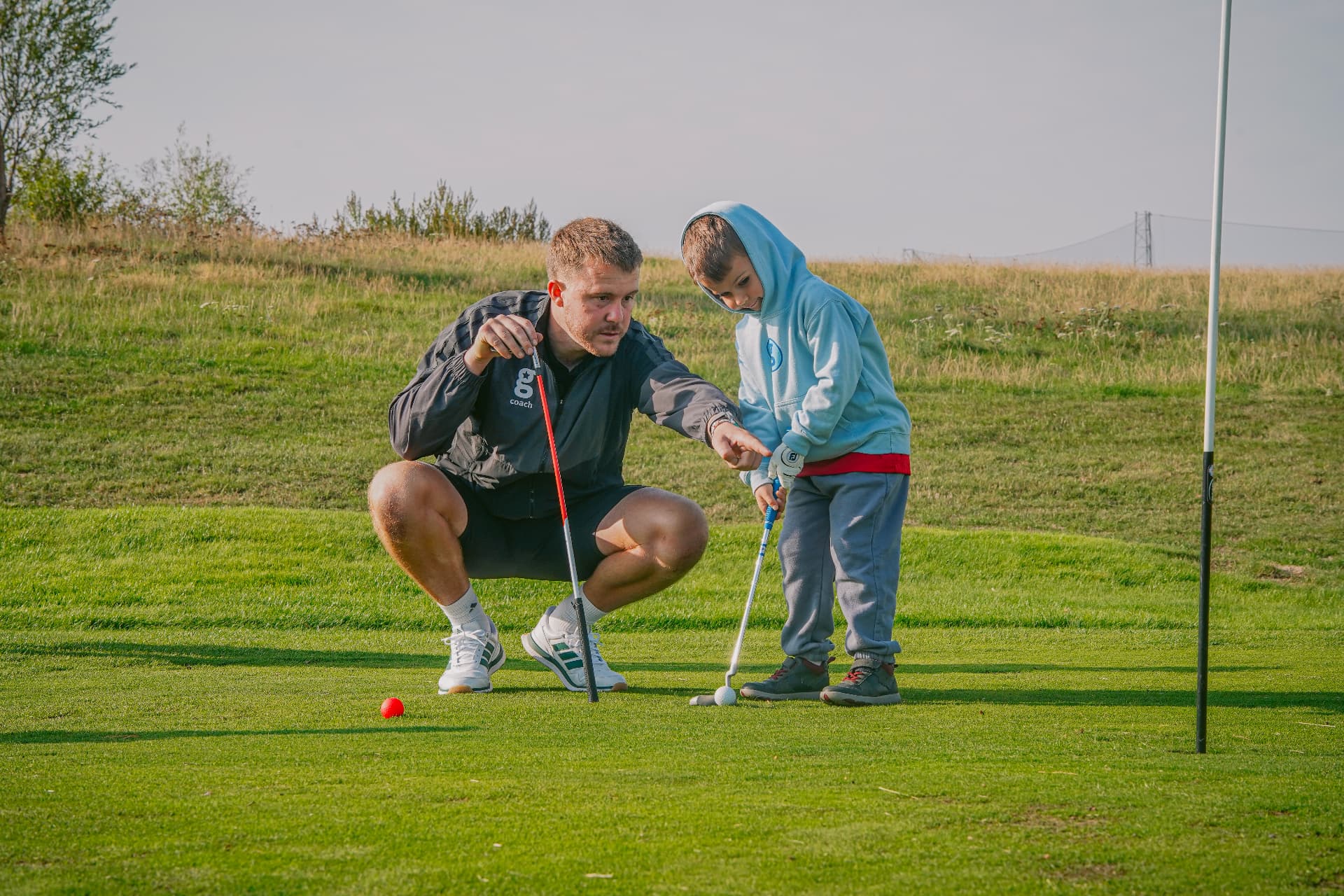 Charlie coaching a young golfer at a golfstars venue